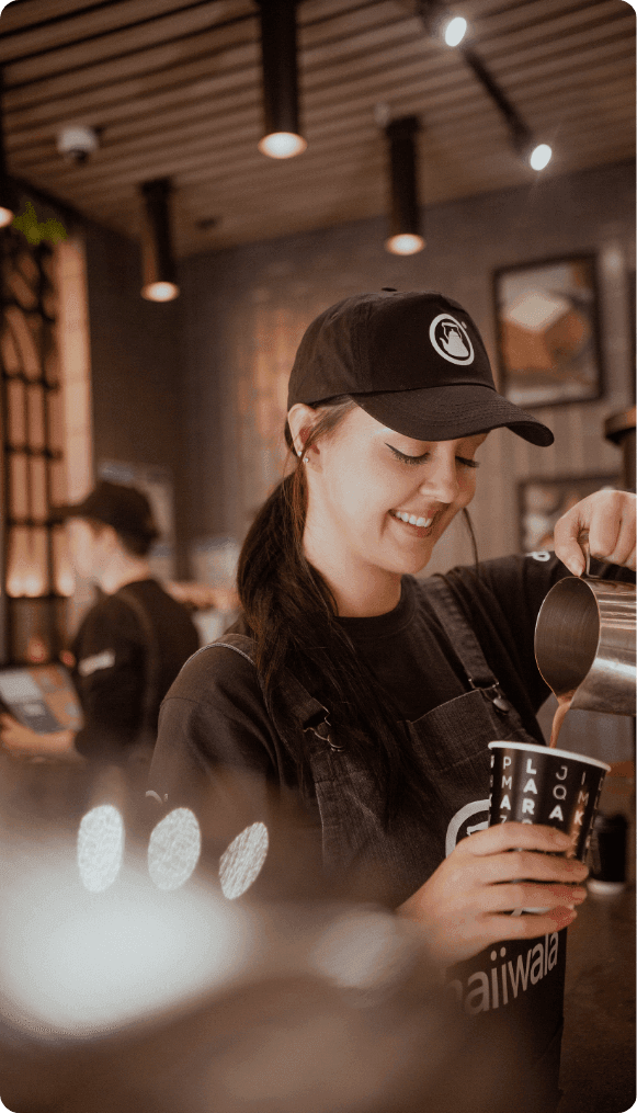 Barista serving a brand campaign drink