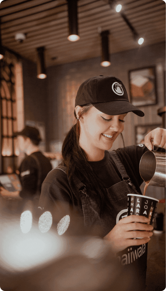 Barista serving a brand campaign drink