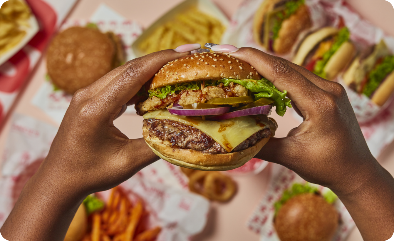 Burger hero held in hands